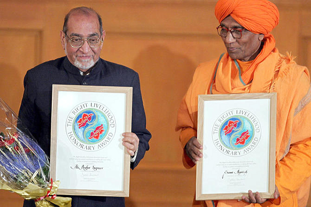 Asghar Ali Engineer, left, and Swami Agnivesh pose with their Right Livelihood Honorary Awards on December 9th, 2004.