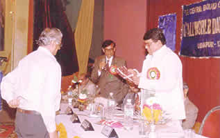 Insaf receiving an award at a mushaira.